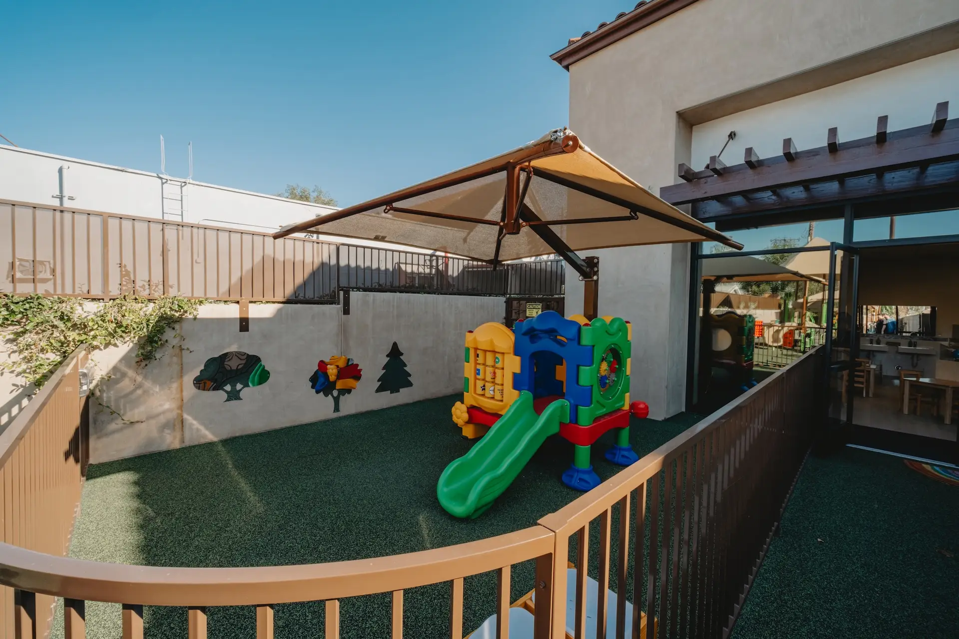 Outdoor play area with slide and playground equipment